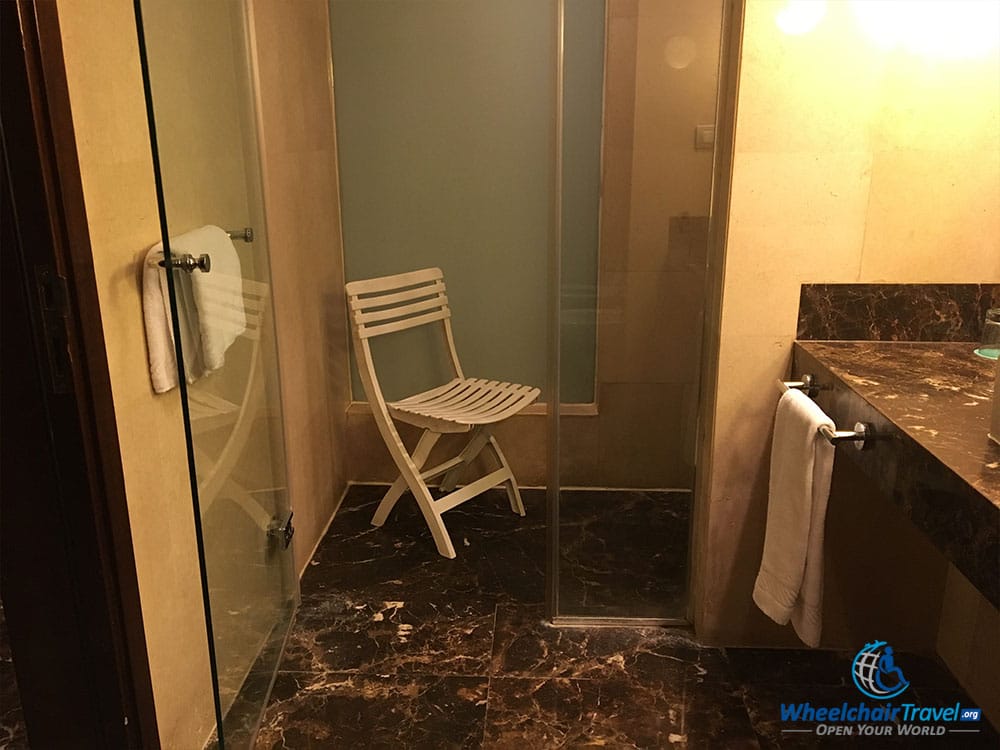 Hotel room shower, enclosed with a glass door