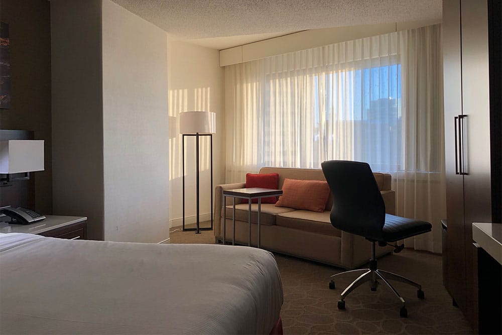 Sofa in front of the hotel room window.