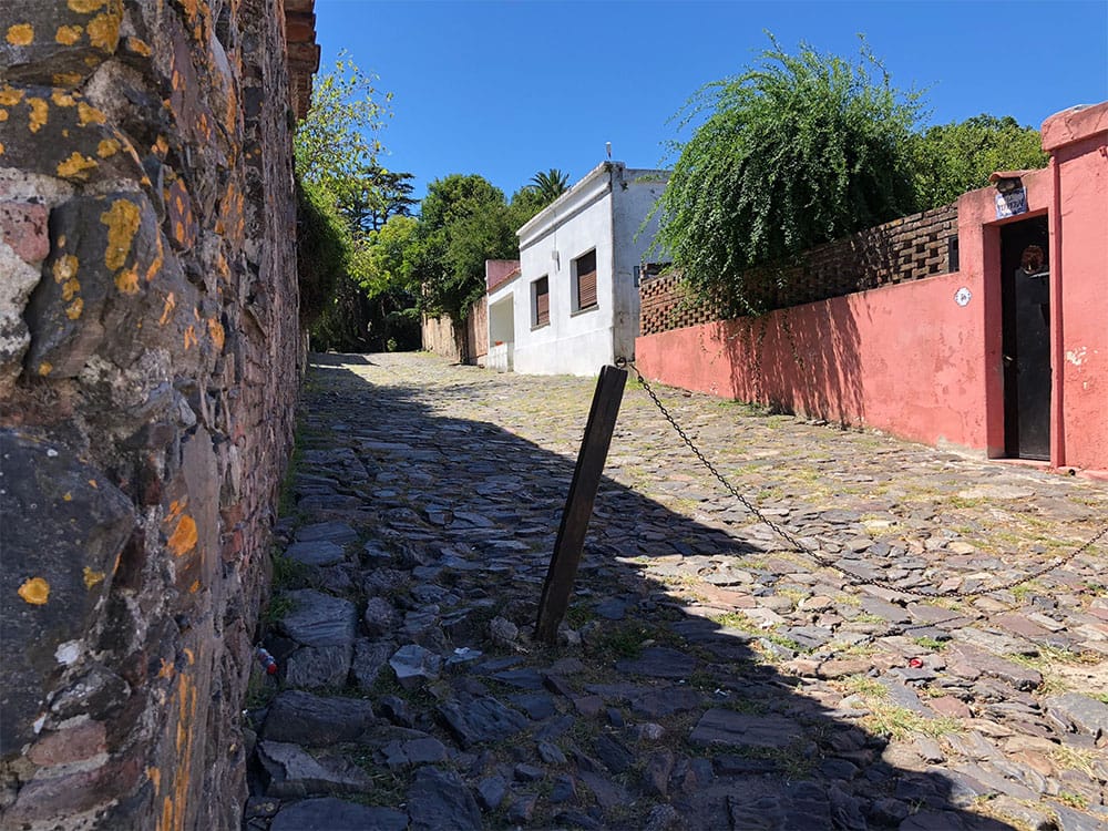 Cobblestone street without sidewalk in Historic Quarter of Colonia.