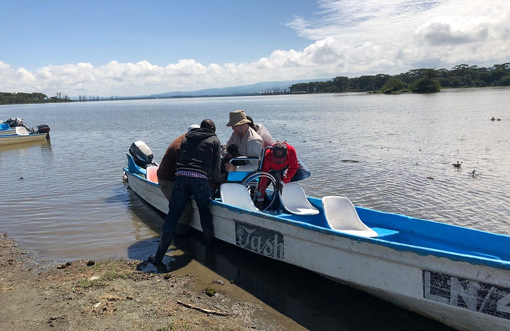 Lifting wheelchair out of boat.