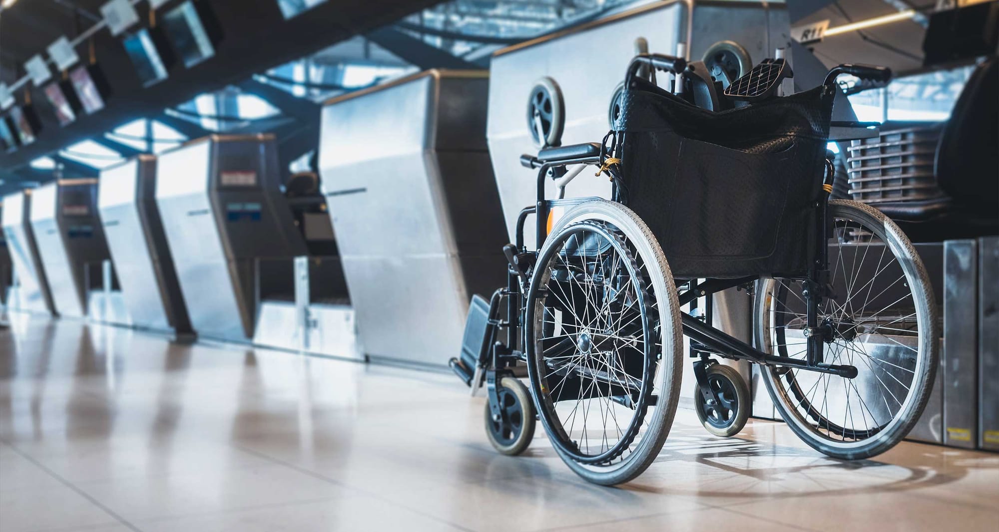 Manual wheelchair at airport check-in counter.