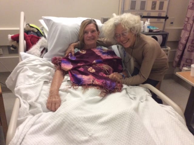 Woman in a hospital bed.