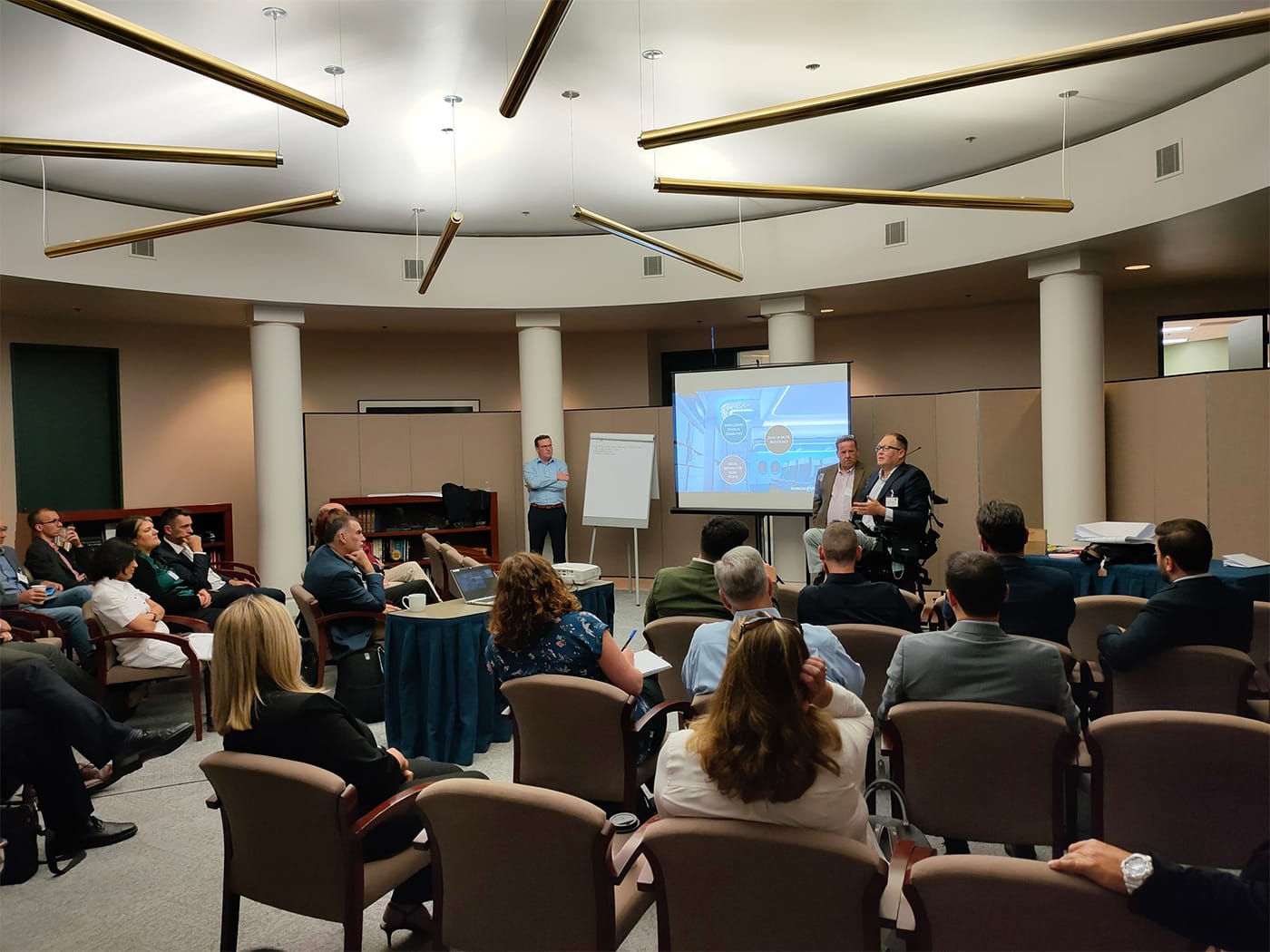 John Morris presenting to a group of attendees.