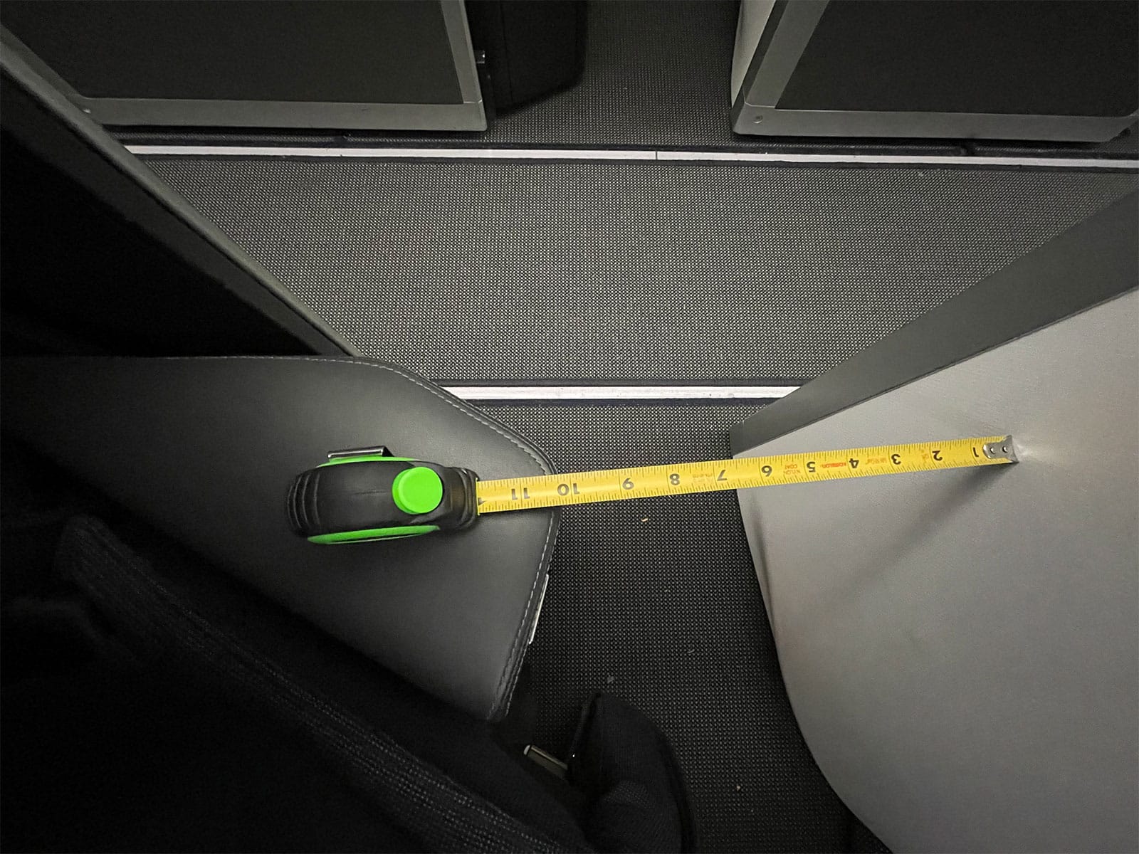 10 inches of clearance between armrests and adjacent seat wall.