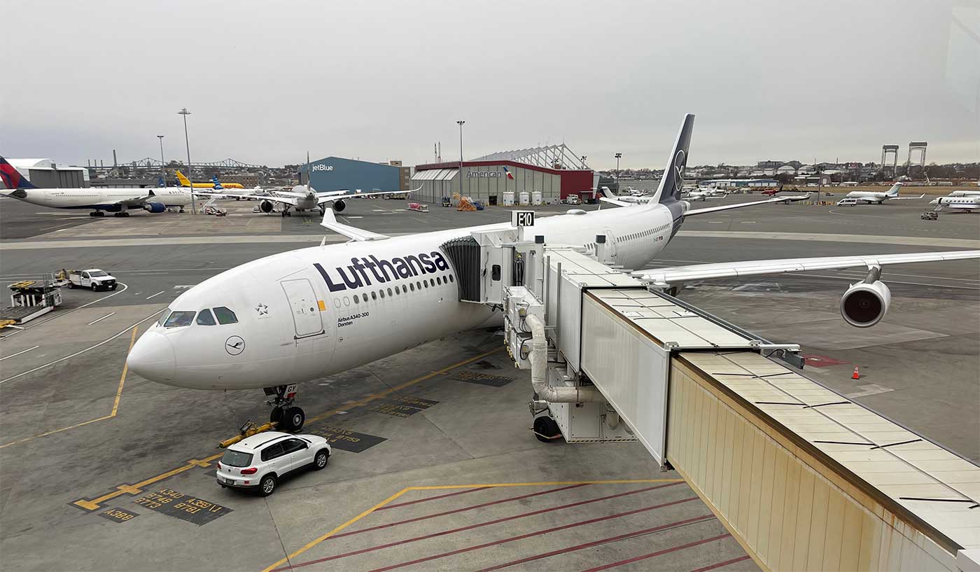 Lufthansa Airbus A340 aircraft parked at Boston Airport gate.