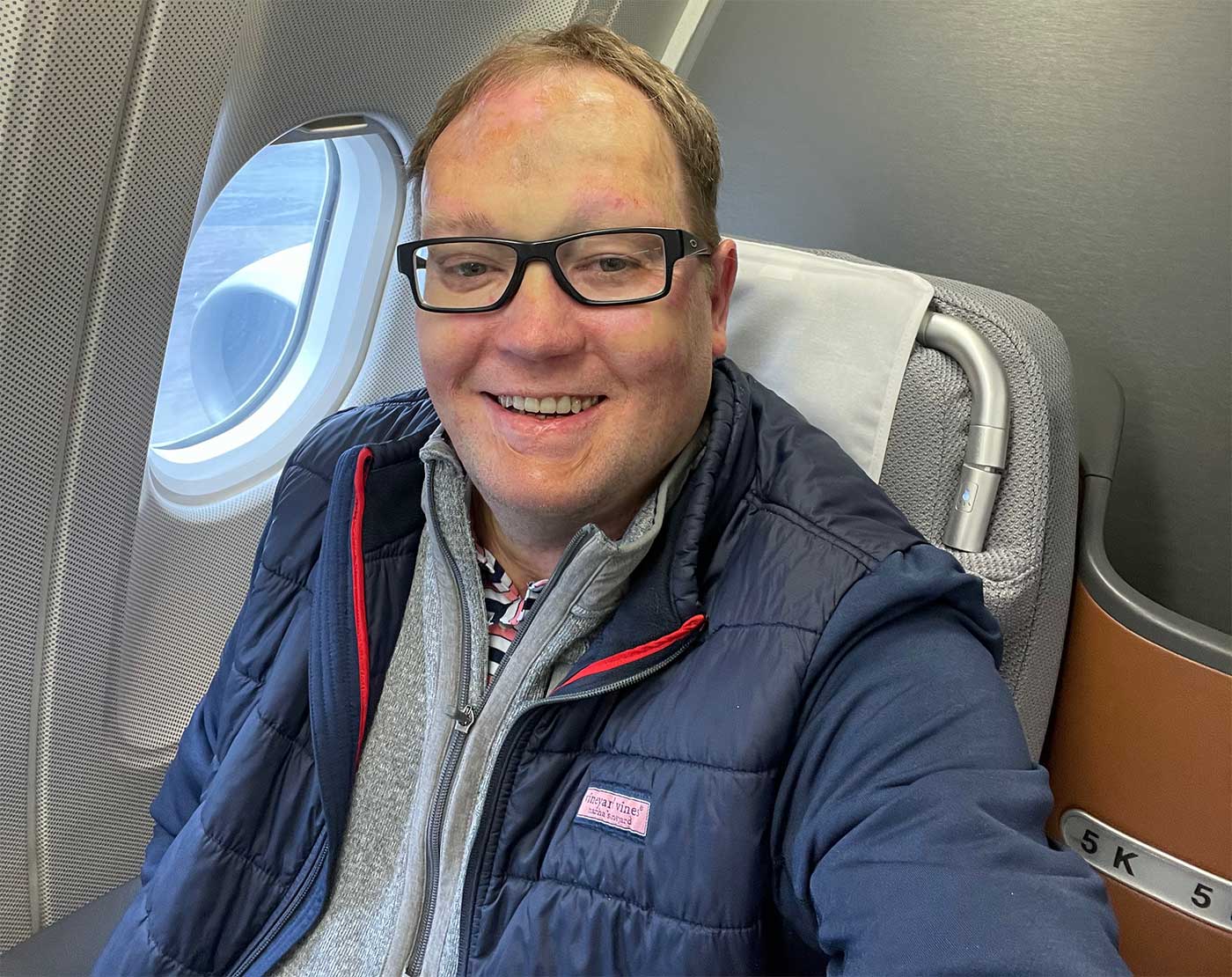 John seated in business class on Lufthansa aircraft.
