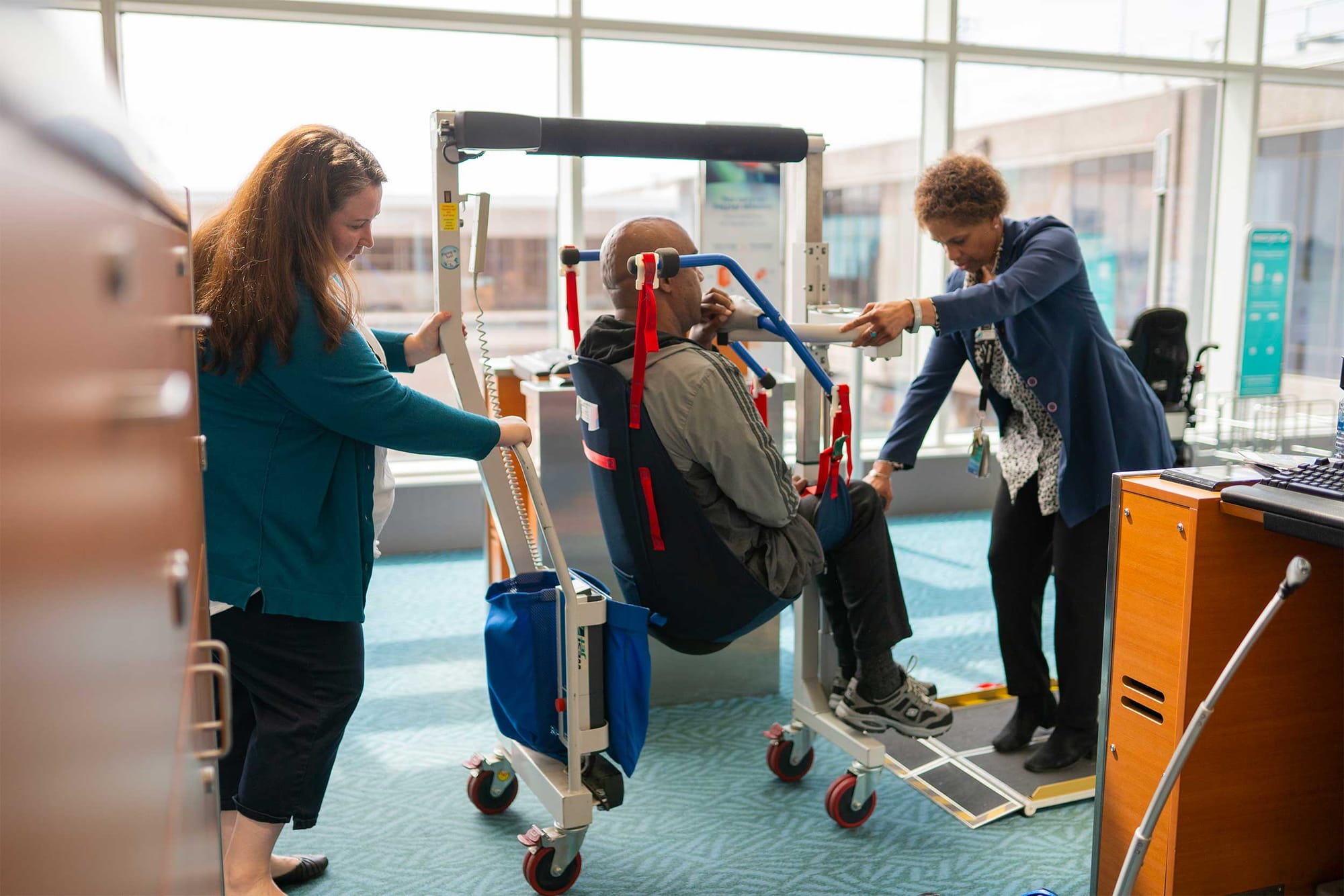 Two WestJet employees demonstrating how the Eagle Lift works at Vancouver Airport.