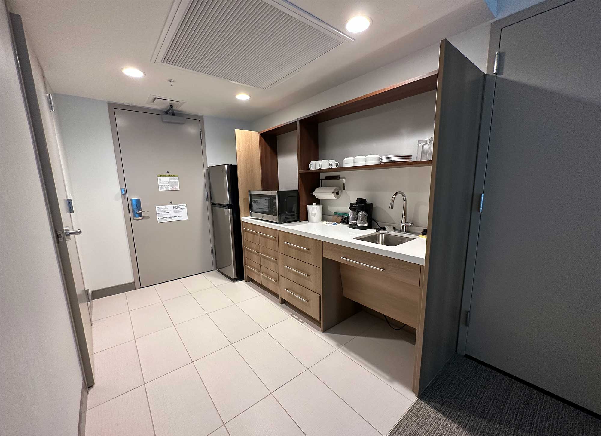 Kitchen area in hotel room entry foyer.
