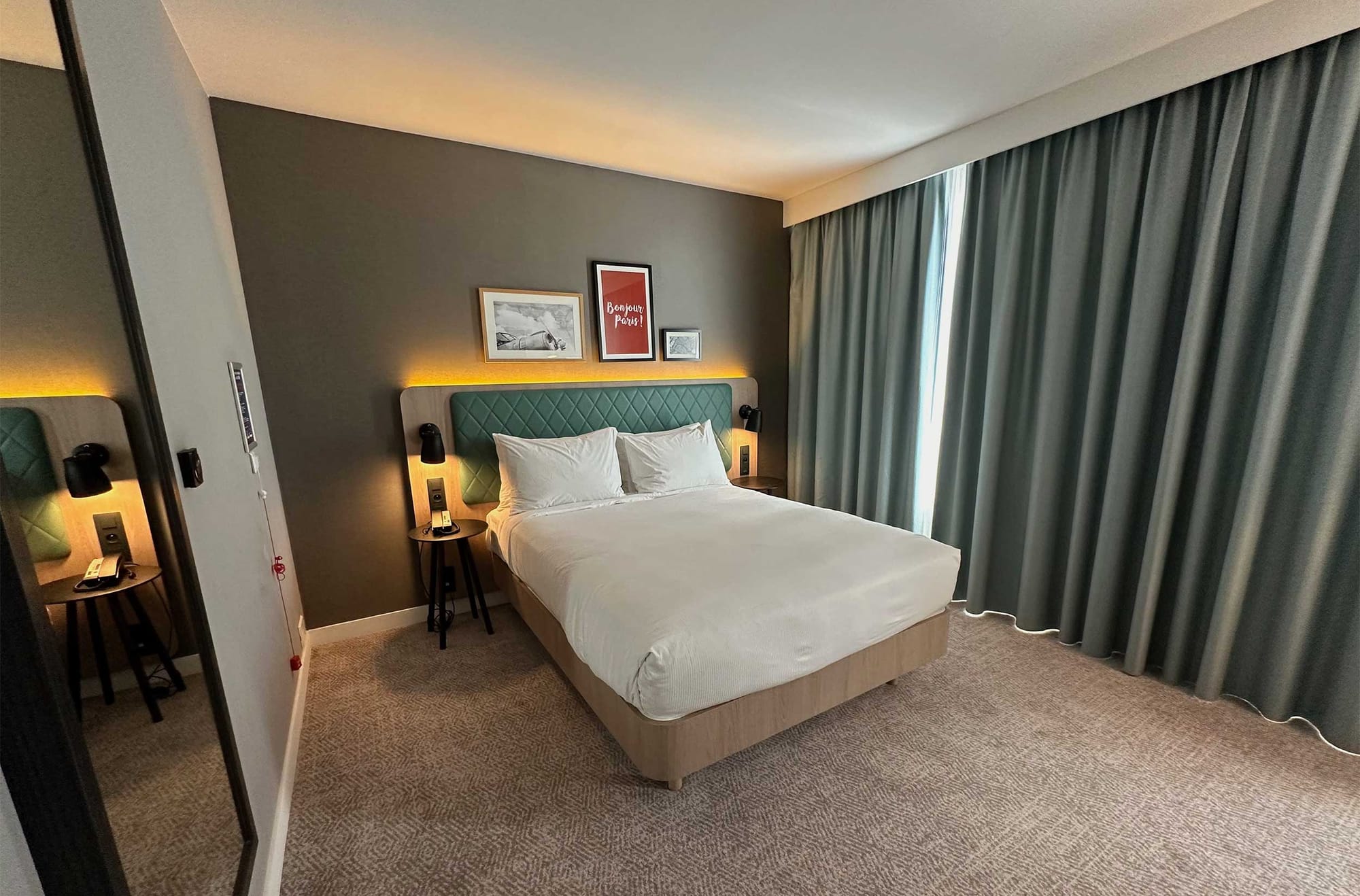 Queen size bed in hotel room.