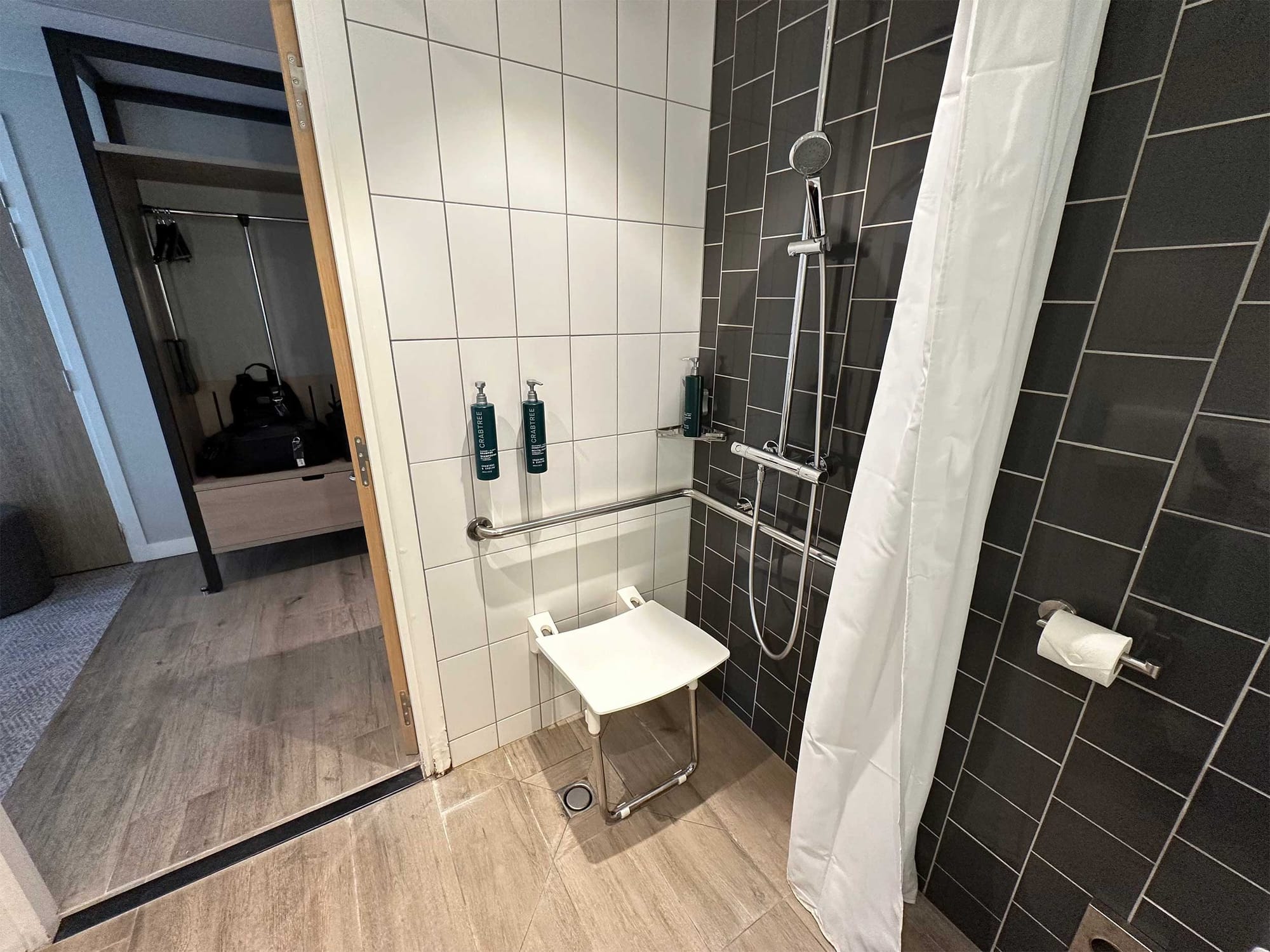 Roll-in shower with grab bars and seat.