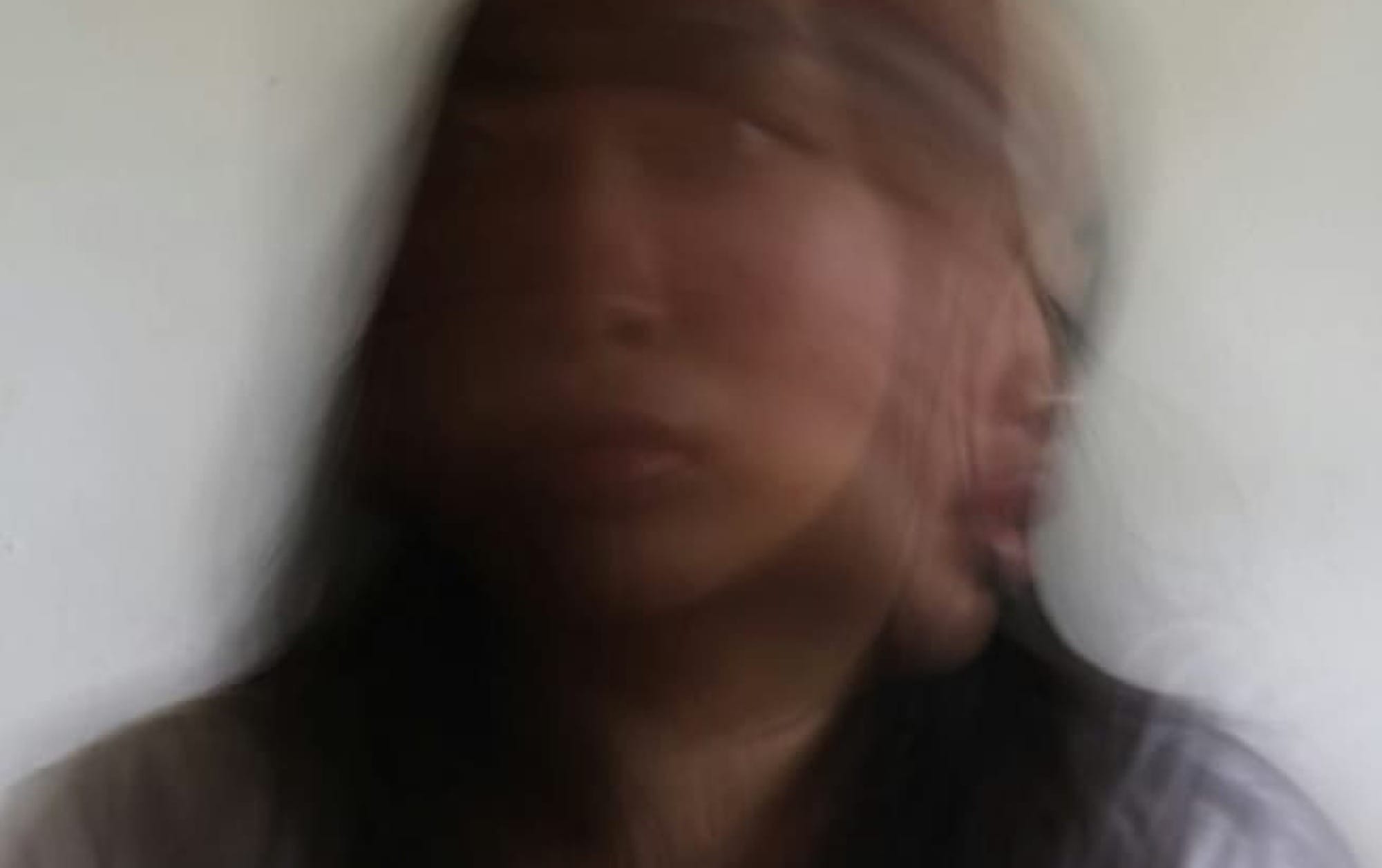 Blurred portrait of a person's face.