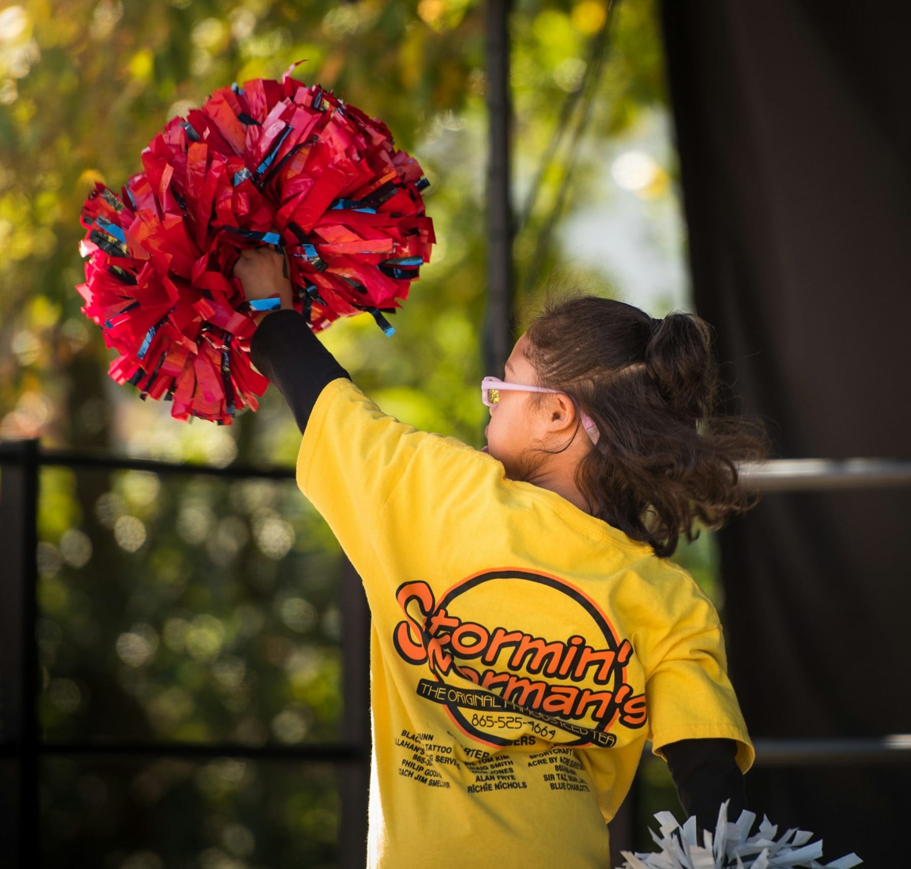girl holding cheer dancer pompom