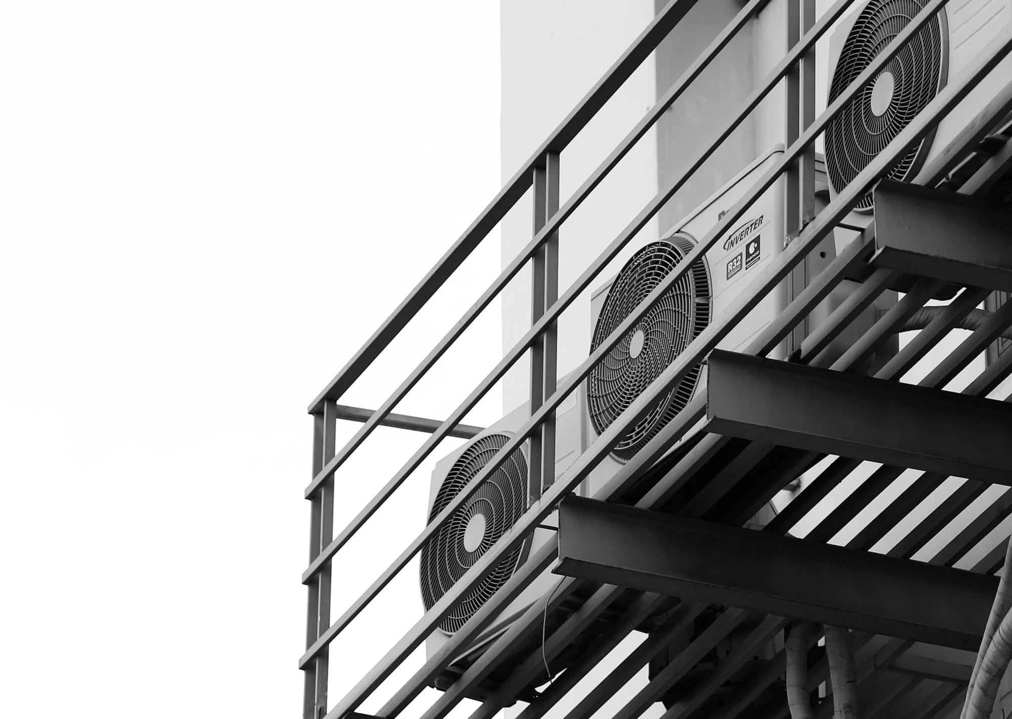 a black and white photo of a clock on a building