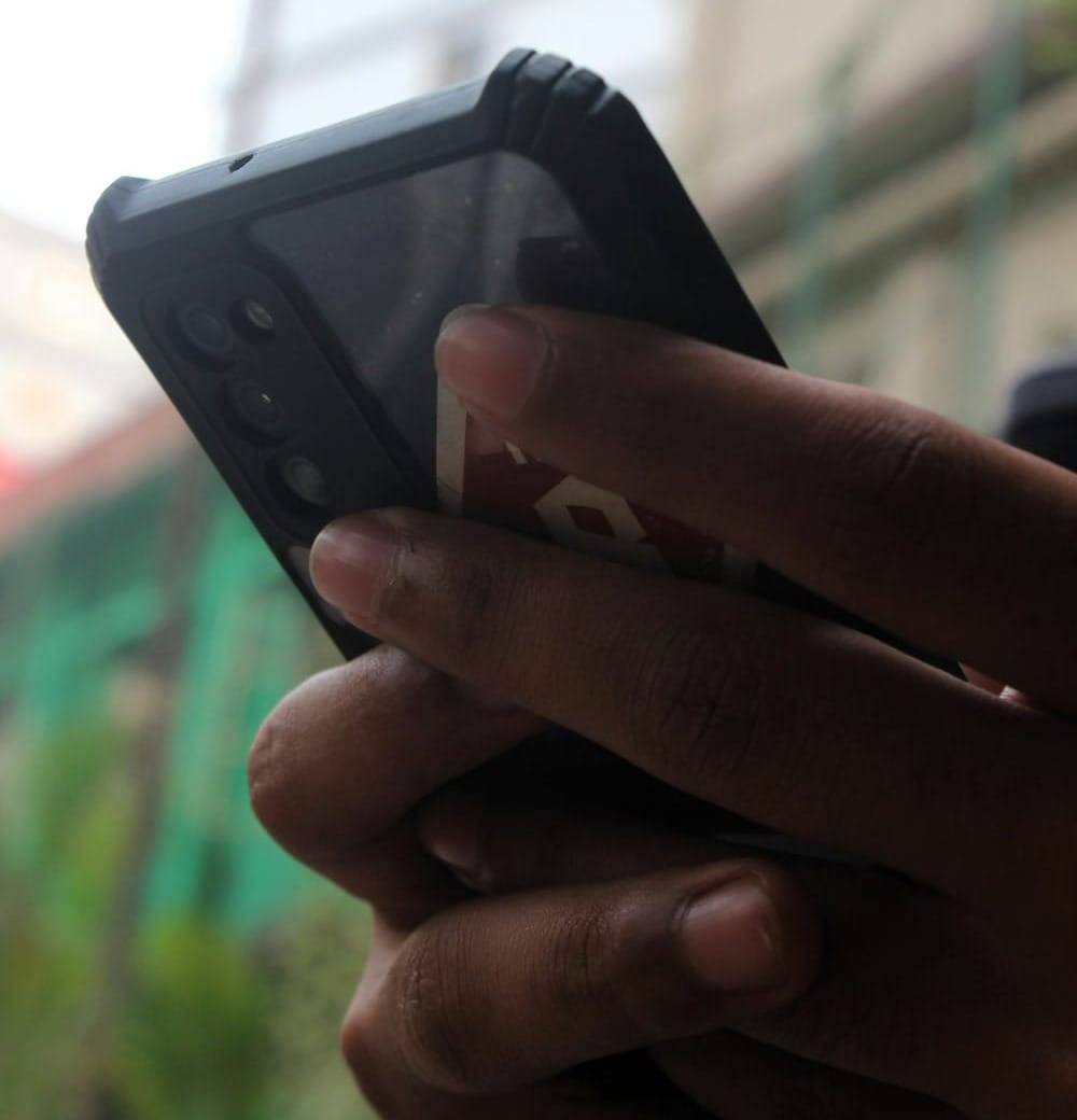 A close up of a person holding a cell phone