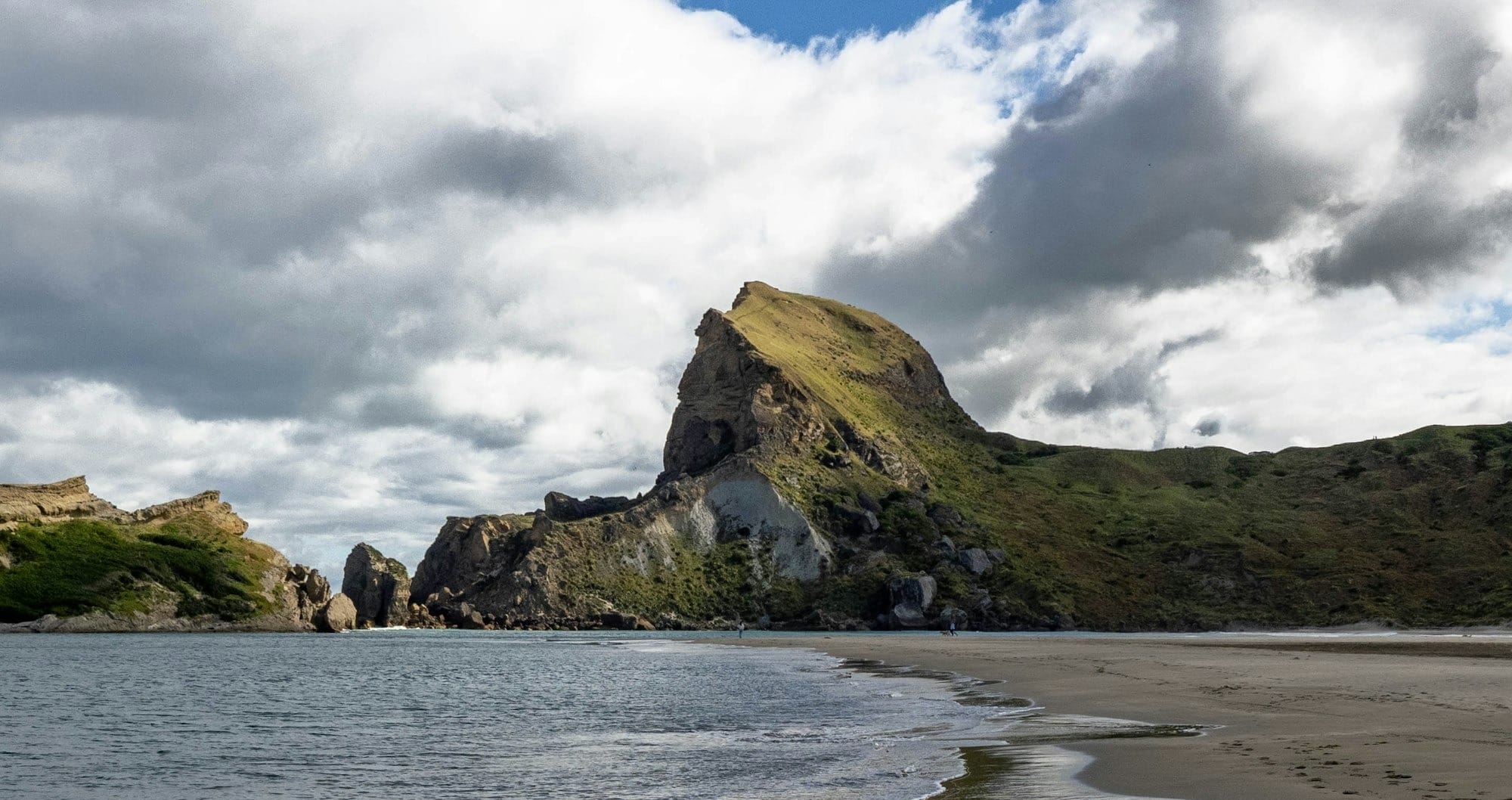A beach with a mountain in the background