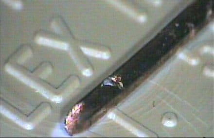 Rigaku laboratory photograph of a copper-wire sample examined for an embedded inclusion