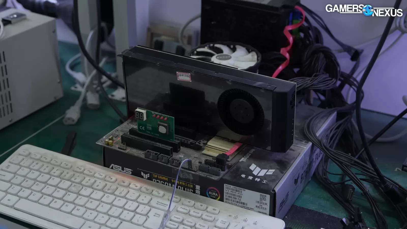 the rebuilt card, with its blower cooler fitted, sits on the shop’s test bench.