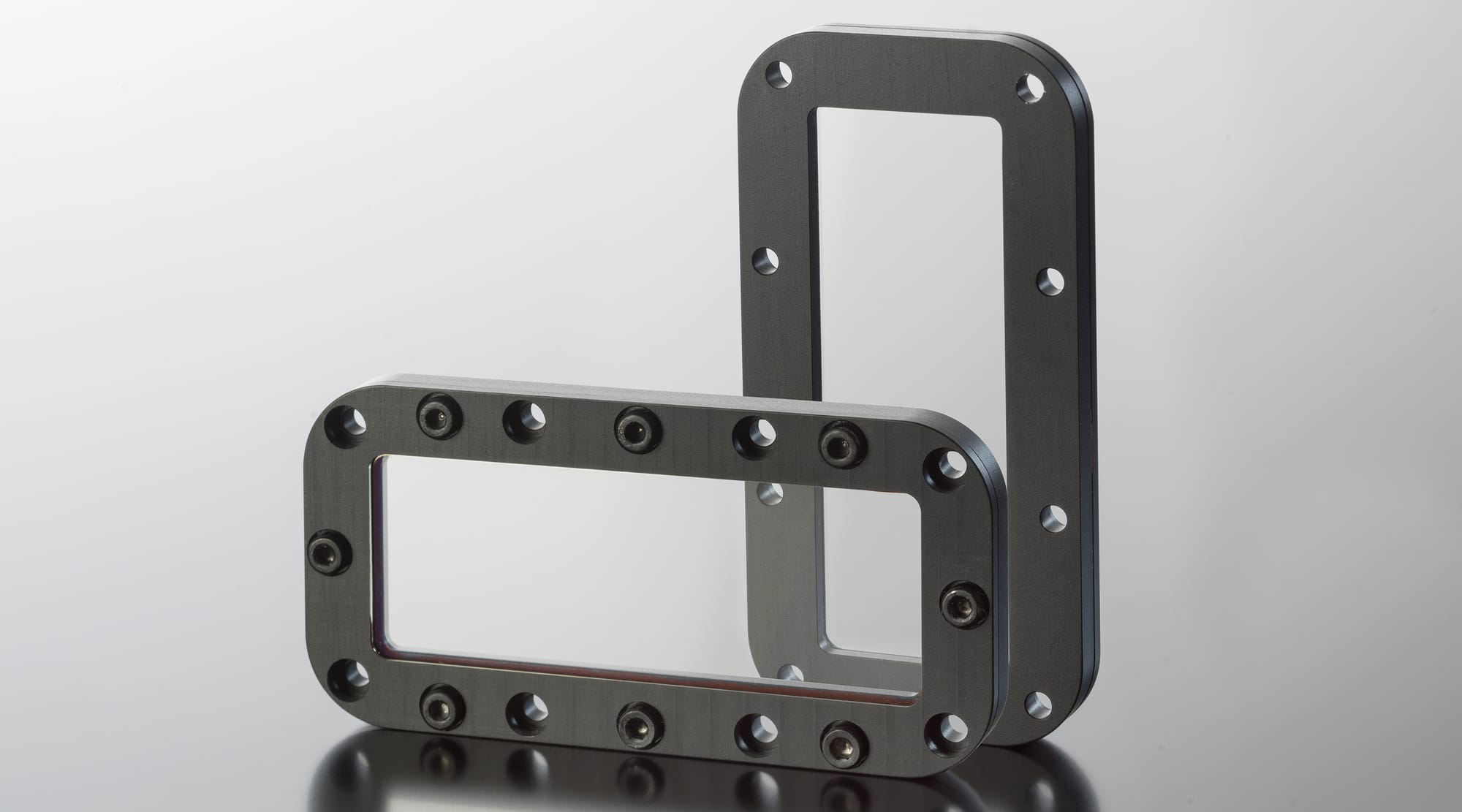 Two SCHOTT zinc sulfide protective optical windows mounted in rectangular metal frames
