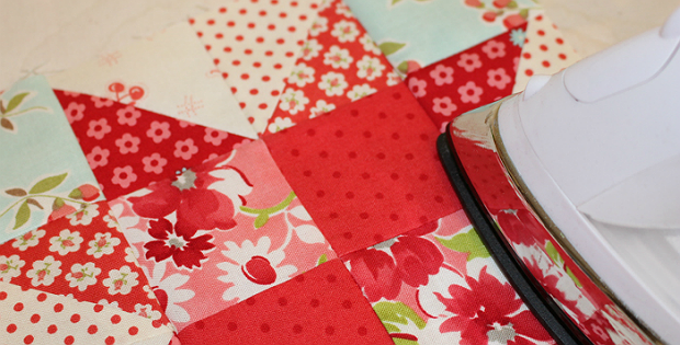 Using a hot iron to press the front of the quilt completely flat