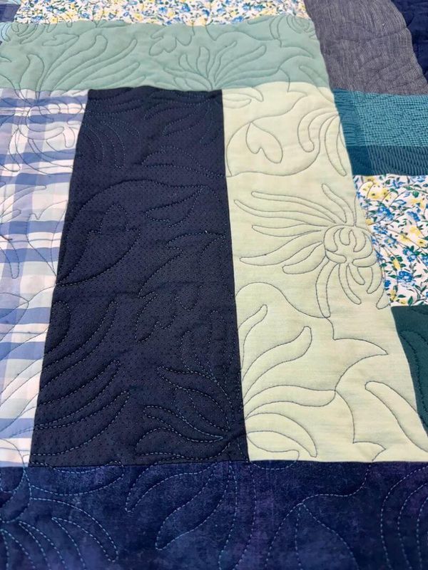 Beautiful blue and teal memory quilt with a spidermum digital design and cuddle backing