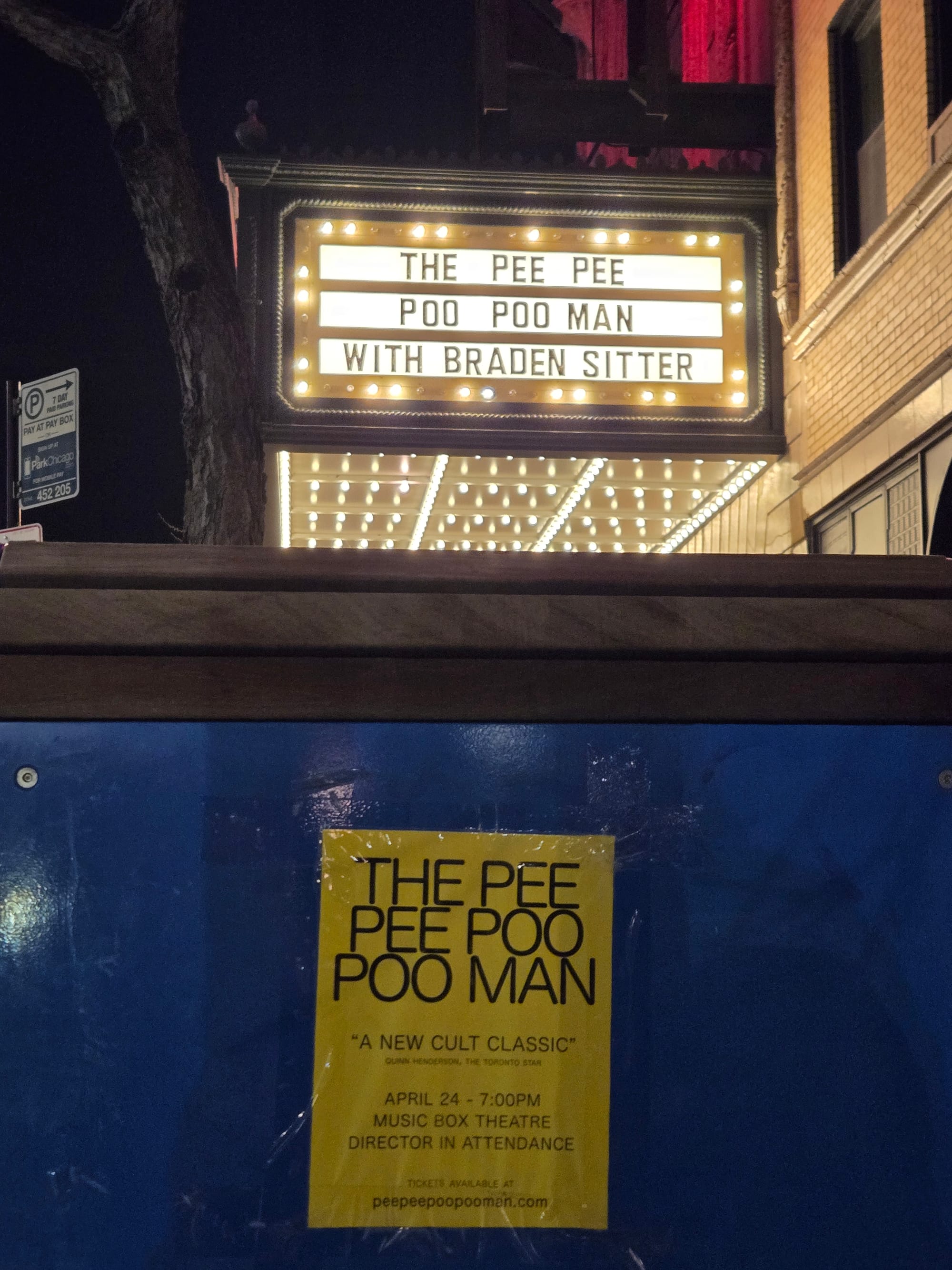 A photo of the Music Box Theatre marquee displaying "The Pee Pee Poo Poo Man with Braden Sitter," with a posted nearby flier for the movie visible in frame.