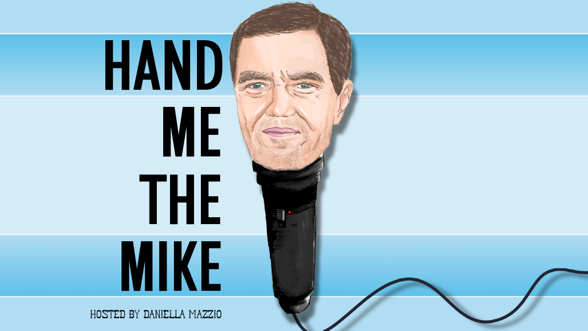 Over a blue striped background, an illustration of Michael Shannon's head atop a microphone. Text reads "Hand Me the Mike," hosted by Daniella Mazzio.