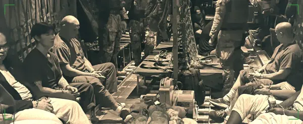 A stylized, sepia-toned image of the South Sudan group being flown to Juba, shackled, on a US military plane.