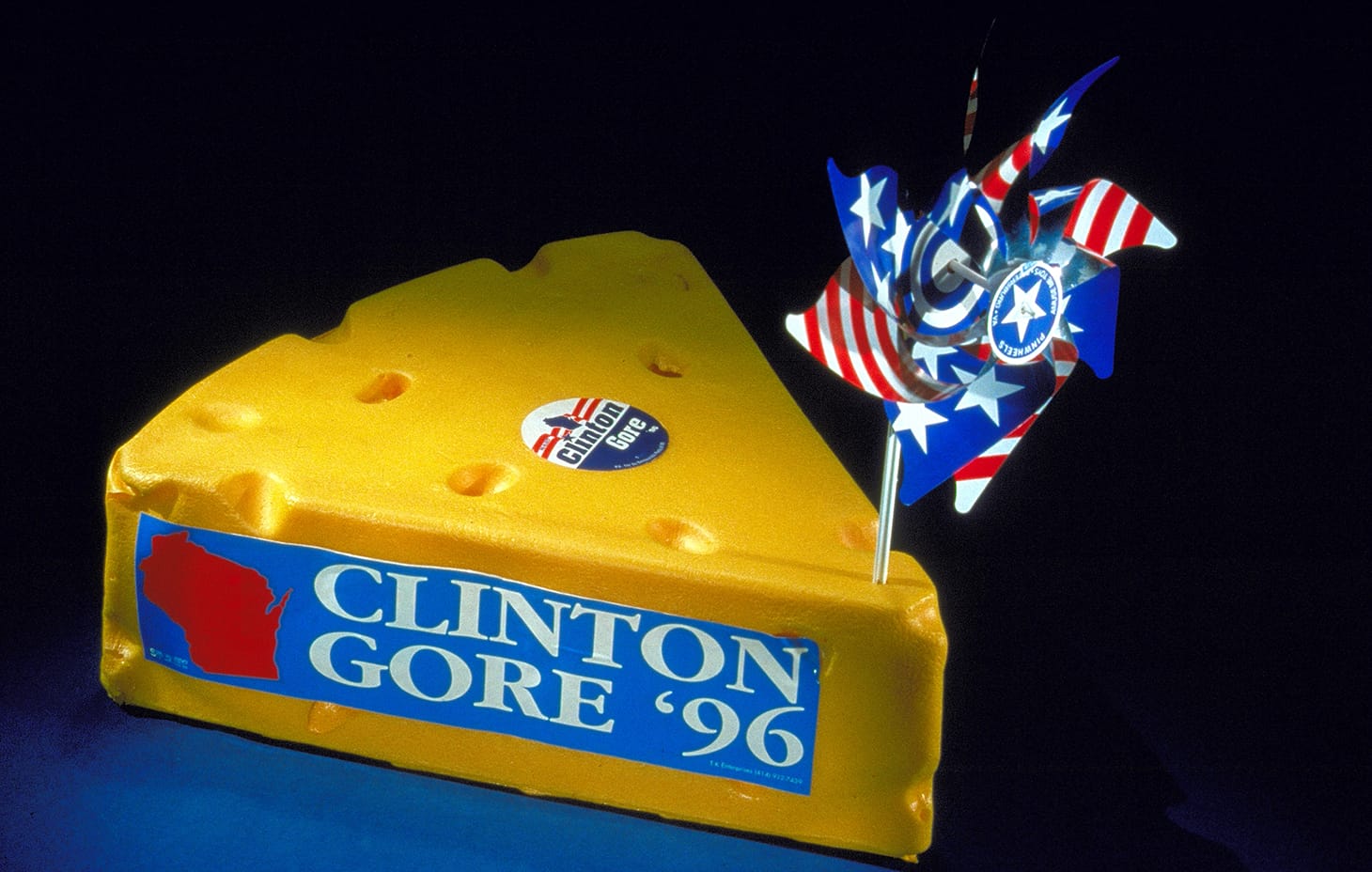 Shaped like a block of swiss cheese, this delegate hat from the 1996 Democratic National Convention is decorated with a "Clinton Gore '96" sticker and other stars and stripes decoration.