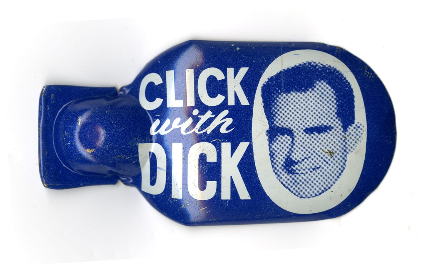 A blue, metal clicker toy is emblazoned with the slogan "Click with Dick" alongside a portrait of the 1960 Republican presidential candidate, Richard Nixon.
