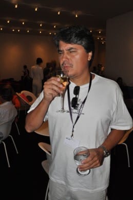 Celso partaking in the free champagne at Art Basel Miami's press preview