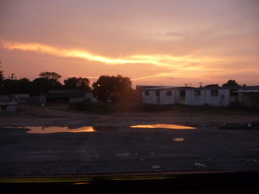 The train brings you through towns you might fly over in a plane and that you wouldn't notice in a car. Few of these towns cater to tourists and therefore lack the diners and motels familiar to road trippers. Above is a photo from somewhere in Alabama, as the sun set over our overnighter.