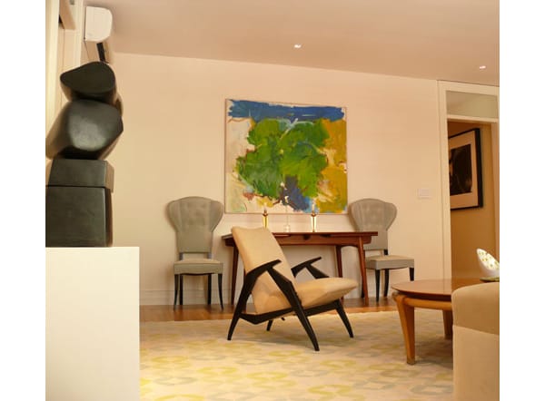 An abstract painting, ‘Fluffy Green Spot’, by Eugene Pizzuto hangs on a wall above a Hans Wegner, 1950s dining table. The side chairs are Italian, 1950s. via newyorksocialdiary.com