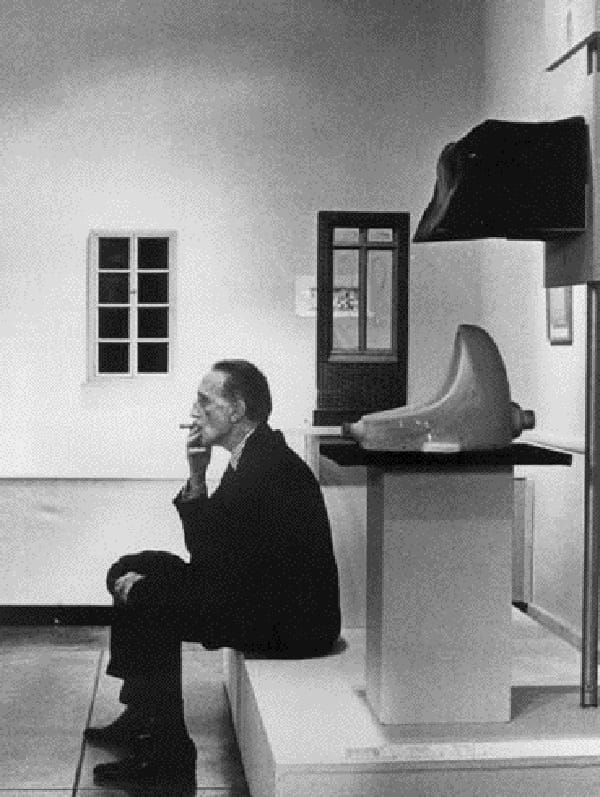 Marcel Duchamp and one his urinals, via artsravel.blogspot.com