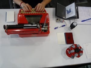 Red figured prominently in her performance, with red fingernails, stamps and a typewriter.