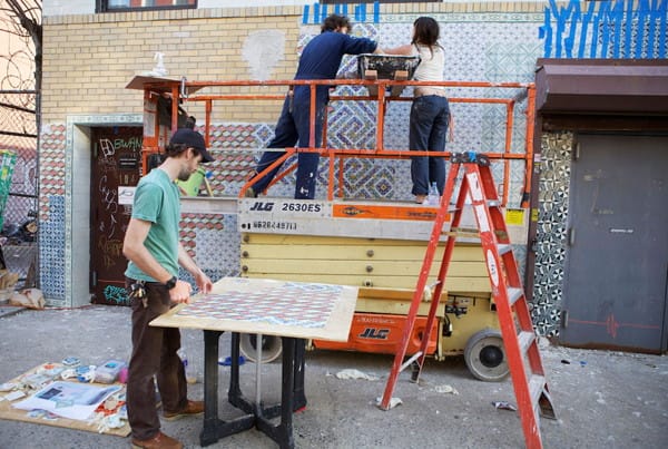 Faile installating the mural