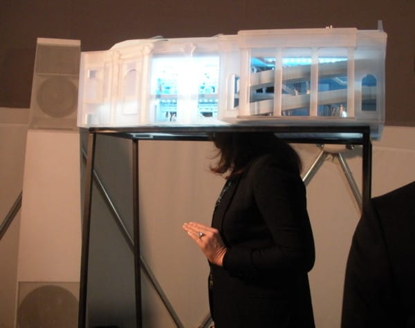 A woman looking inside the architectural model for the institute (photo by Jillian Steinhauer for Hyperallergic)