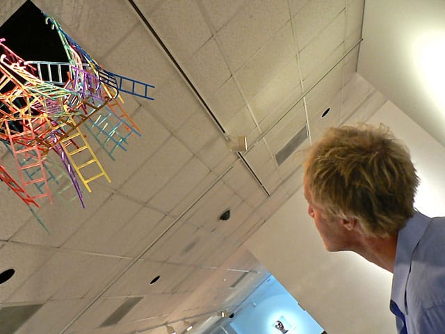The artist looking up at his sculpture "Ladder Nest"