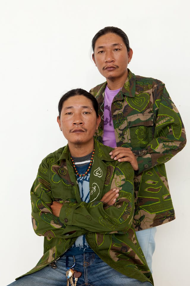 Thanh (seated) and Hai (standing) in the hybrid uniforms