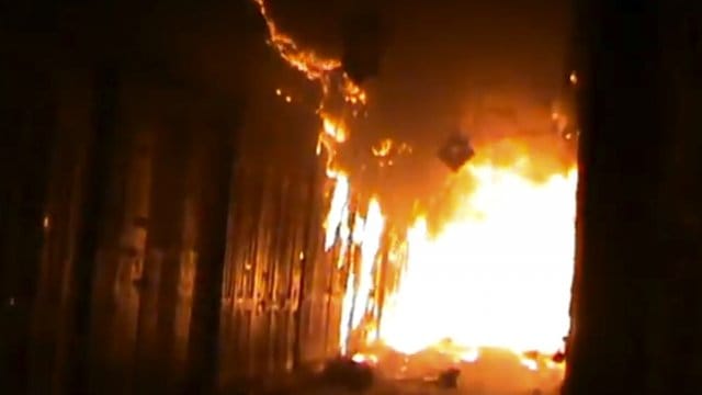 A screenshot of BBC video shows Aleppo's ancient souk engulfed in flames. (via BBC)
