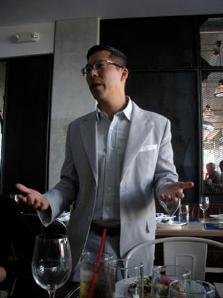 Artlantic curator Lance Fung speaking at the Miami press lunch