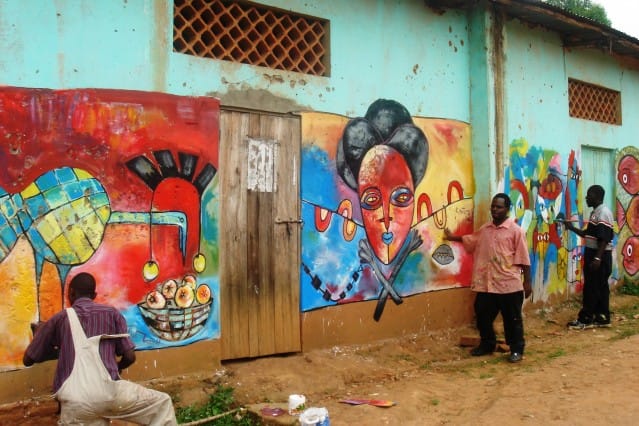 Muralists Paul Kintu, Patrick Kyeswa and Hassan Mukiibi work on the community center at Weaver Bird. Image courtesy Start Journal. (Click to enlarge)