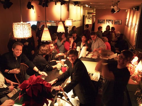 Ellie Covan at the bar in Dixon Place's lounge. From the DP website.