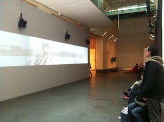 Visitors watch Xu Bing's The Character of Characters, an animated short. Photo by the author.