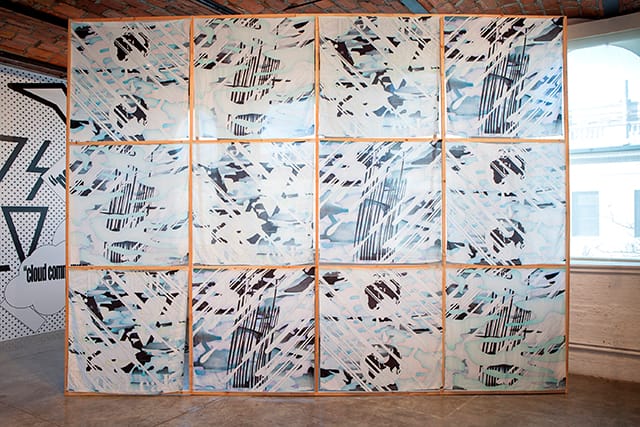 Installation view of "Metahaven: Islands in the Cloud" at MoMA PS1featuring Wikileaks scarves (Photo: Matthew Septimus)