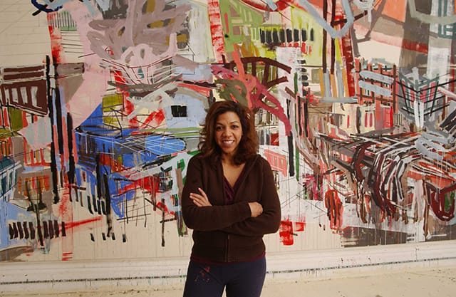 Denyse Thomasos in front of her painting "Babylon" (2005) (Image courtesy Olga Korper gallery)