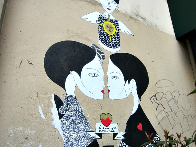 An angelic character over two figures