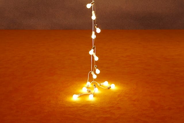 Felix Gonzalez-Torres, "Untitled (Couple)" (1993). Light bulbs, porcelain light sockets, and extension cords (two parts); dimensions variable. Collection Mr. and Mrs. Jeffrey R. Winter; Rudolf Stingel, "Untitled" (1991/2012). Carpet; dimensions variable. Courtesy the artist, Paula Cooper Gallery,New York, and Massimo de Carlo, Milan. (Image courtesy the New Museum) 