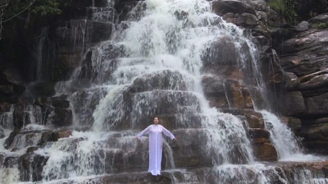Marina in front of a waterfall in Brazil (screen shot via Vimeo)