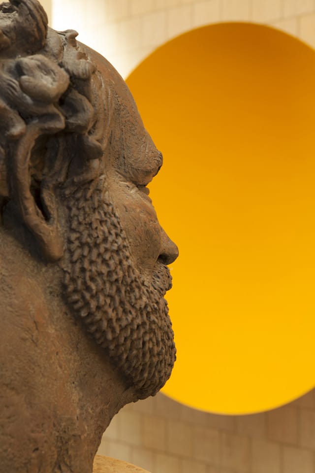 Robert Arneson Ecstasy of a Mud Stomper, 1983 and Untitled (Yellow Wall Disk), unknown year.  Photo by Ross Gordon, Courtesy of Al Shands. “I am looking for a certain ambiguity, slightly unsettled. That is what you find in the Sol LeWitt. You think you can solve the problem, but then it presents new problems. You can never get to it, it is unsolvable. You can solve it different ways. That is what I want in art. One of my favorite pieces is the Anish Kapoor. It requires you to get into it. You have to make a decision to raise your hand.