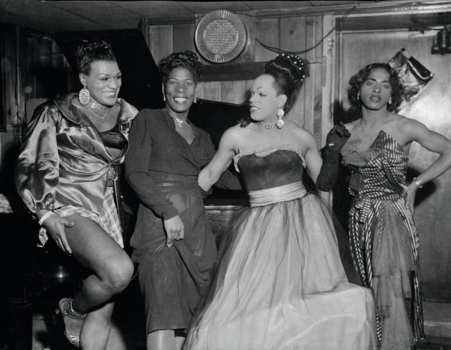 Charles ‘ Teenie’ Harris, Group portrait of four cross-dressers posing in a club or a bar in front of a piano, including Michael ‘Bronze Adonis’ Fields, on left, and possibly ‘Beulah’ on right, 1955, black and white photograph (Collection: Carnegie Museum of Art, Pittsburgh)